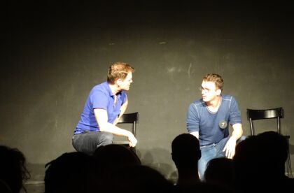 Two improv players on stage
