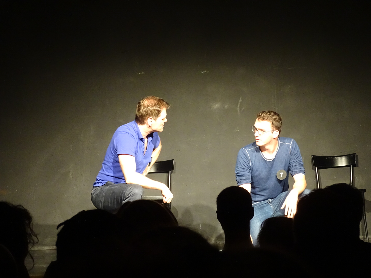 Two improv players on stage